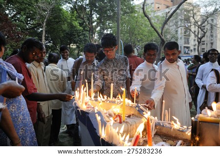 KOLKATA - MARCH 16 : Christian priests and protesters lighting candles  during a candle light vigil to protest gang rape of an elderly nun on March 16, 2015 at Allen Park in Kolkata, India.