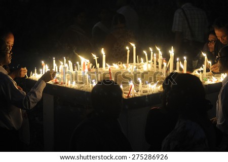 KOLKATA - MARCH 16 : Mourners lighting candles during a candle light vigil to protest gang rape of an elderly nun near Ranaghat on March 16, 2015 at Allen Park in Kolkata, India.