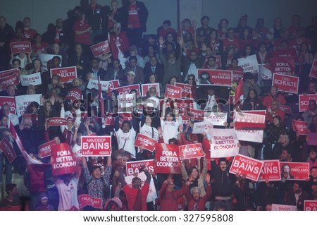 BRAMPTON - OCTOBER 4 : Liberal party supporters chanting slogans and hoisting banners during an election rally of the Liberal Party of Canada on October 4, 2015 in Brampton, Canada.