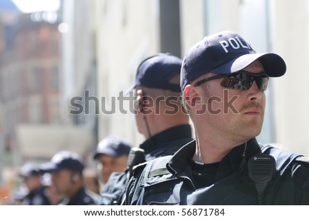 TORONTO-JUNE 25:  Toronto Police officers keeping a close eye on the rally during the G20 Protest on June 25, 2010 in Toronto, Canada.