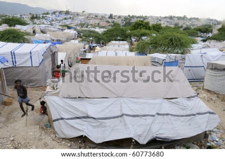 PORT-AU-PRINCE - AUGUST 28:  People walking on the walkways of a tent city, on August 28, 2010 in Port-Au-Prince, Haiti