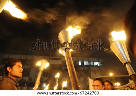 BHOPAL- DECEMBER 2: Victims hold their torches  during the torch rally organized to mark the 26th year of Bhopal gas disaster, in Bhopal - India on December 2, 2010.