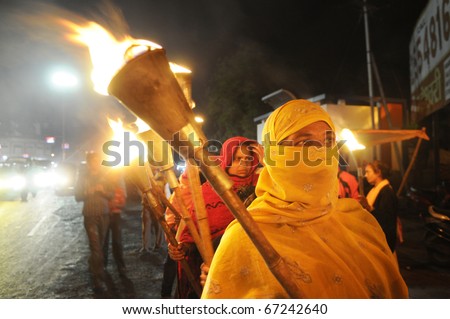 BHOPAL- DECEMBER 2: A Muslim woman carry a torch during the torch rally organized to mark the 26th year of Bhopal gas disaster, in Bhopal - India on December 2, 2010.