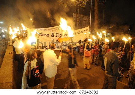 BHOPAL- DECEMBER 2:  Protesters march  during the torch rally organized to mark the 26th year of Bhopal gas disaster, in Bhopal - India on December 2, 2010.