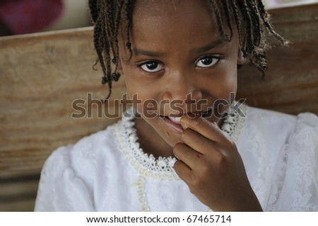 PORT-AU-PRINCE - AUGUST 22: A smiling unidentified kid during a food distribution camp in a broken church ,in Port-Au-Prince, Haiti on August 22, 2010.