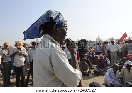 KOLKATA- FEBRUARY 13:  A follower chewing a pouch packet of water during a political rally  in Kolkata, India on February 13, 2011.