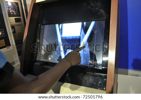 KOLKATA- FEBRUARY 20: A  human finger plays around with a touch screen, during the Information and Communication Technology (ICT) conference and exhibition in Kolkata, India on February 20, 2011.