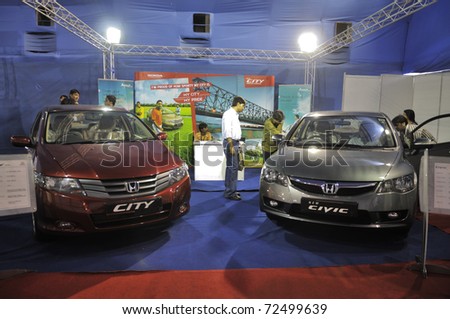 KOLKATA- FEBRUARY 20:  Visitors looking into their options of buying a Honda car,during the Information and Communication Technology  conference and exhibition in Kolkata, India on February 20,2011.