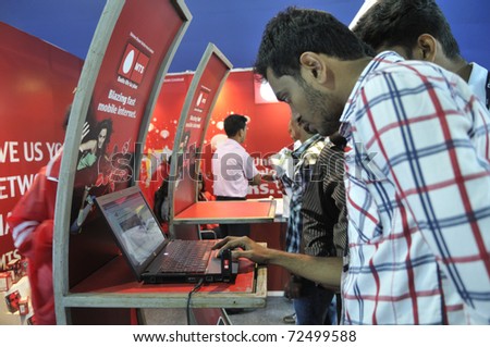 KOLKATA- FEBRUARY 20:Curious customers checking the speed of an internet stick during the Information and Communication Technology (ICT) conference and exhibition in Kolkata,India on February 20,2011.