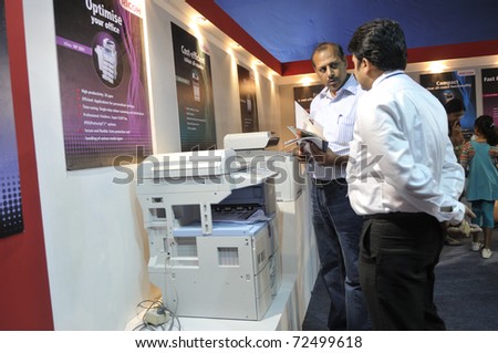 KOLKATA- FEBRUARY 20: A customer asking questions about a  photocopier, during the Information and Communication Technology (ICT) conference and exhibition in Kolkata, India on February 20, 2011.