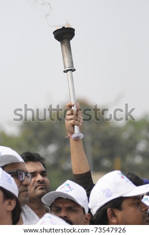 KOLKATA - FEBRUARY 20: Supporters of All India Trinamool Congress holding a flamed torch  during a rally organized to kick the 2011 election champagne, in Kolkata, India on February 20, 2011.