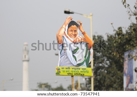 KOLKATA - FEBRUARY 20: All India Trinamool Congress Supporters with a cut out of Ms.Mamata Banerjee during a rally organized to kick the 2011 election champagne,in Kolkata,India on February 20,2011.