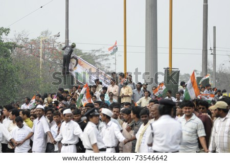 KOLKATA - FEBRUARY 20: Supporters of All India Trinamool Congress stick their party flag to a pole during a rally organized to kick the 2011 election champagne, in Kolkata, India on February 20, 2011.