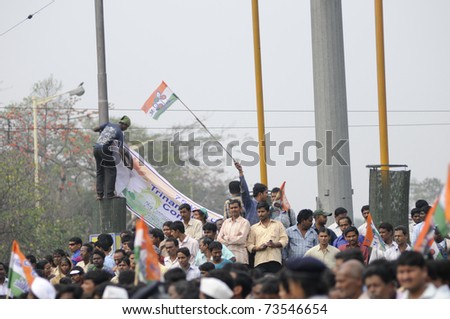 KOLKATA - FEBRUARY 20:Supporters of All India Trinamool Congress trying to catch glimpses of  leaders during a rally organized to kick the 2011 election champagne, in Kolkata,India on February 20,2011.