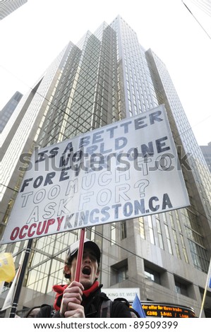 TORONTO - NOVEMBER 24:  An occupy protester chanting slogans in front of the Toronto Stock Exchange during a rally on November 24, 2011 in Toronto, Canada.