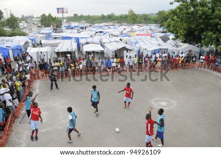 PORT-AU-PRINCE - AUGUST 26:  Teams playing a  friendly soccer match in one of the tent cities in Port-Au-Prince, Haiti on August 26, 2010.