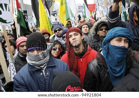 TORONTO - JANUARY 10: A group of Arab youths listening to the speakers during a rally to condemn the Israel occupation on Gaza on January 10 2009 in Toronto, Canada.