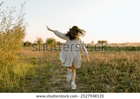 Similar – Image, Stock Photo Little girl on a meadow full of heather at sunset