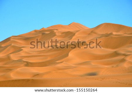 PIQAN, CHINA Ã¢Â?Â? SEPTEMBER 4: Kumtag Desert on September 4, 2013 in Piqan, China. Kumtag desert is the only desert linking with city in the world.