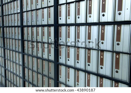 post office boxes letterboxes metal with brown numbers. uniform postboxes in line row organised pattern