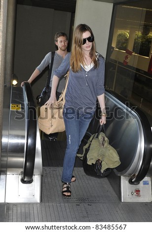 LOS ANGELES-MARCH 30: Actress Anne Hathaway with boyfriend at LAX airport. March 30 in Los Angeles, California 2011