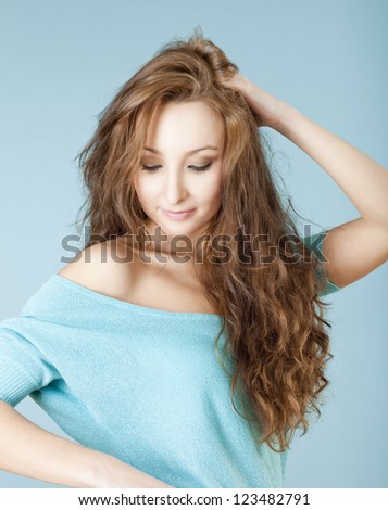 portrait of a young beautiful woman with brown hair looking down