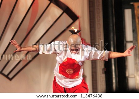 CHENGDU - SEPTEMBER 8: Chinese artists perform traditional candle martial art onstage at Chengdu Theater on September 8, 2005 in Chengdu, Sichuan Province in China