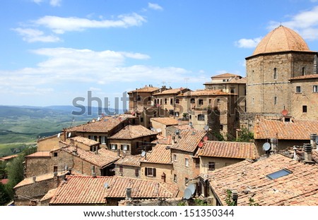 old village of Volterra overlooking Tuscan fields, Italy