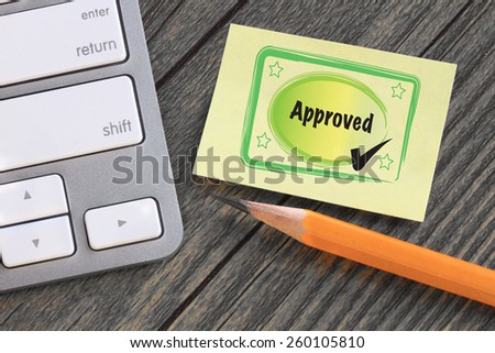 concept of approval, with approved stamp on a note