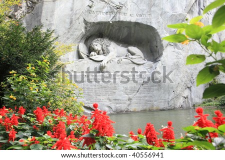 the famous dying lion monument of Lucerne, framed by flowers