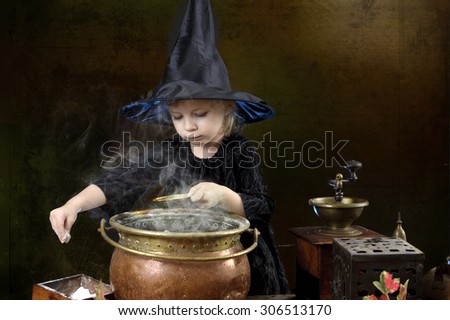 little halloween witch with cauldron