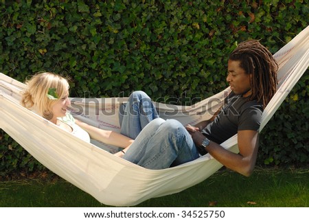 young multi ethnic couple in hammock