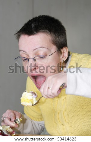 woman,  mouth wide openeating big spoon ful of cake