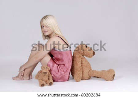 Lovely blond woman in nightie with teddy bears