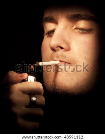 Young Man Lighting A Cigarette. Focus Emphasis On Lighter And Flame ...