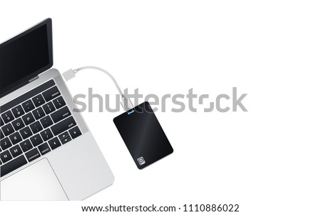 Top view a half of modern laptop computer Connect with Portable 2.5 inch External Harddrive via USB Cable Isolate on white background.Copy space for insert content.