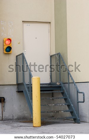 Loading dock stairs, door and a red light signaling trucks can not unload