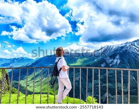 Similar – Image, Stock Photo Tourists gazing at breathtaking snowy mountain slope