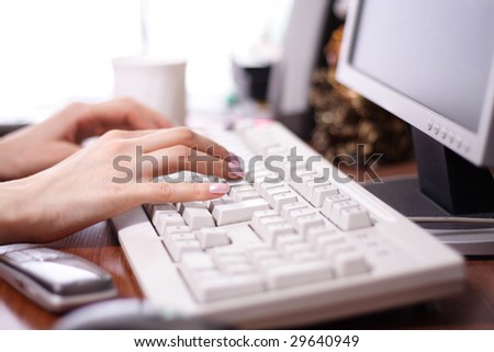 close up of female hands printing on the keyboard