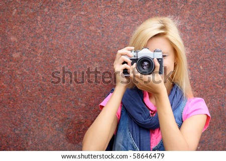 photographer with old camera on a background of a wall
