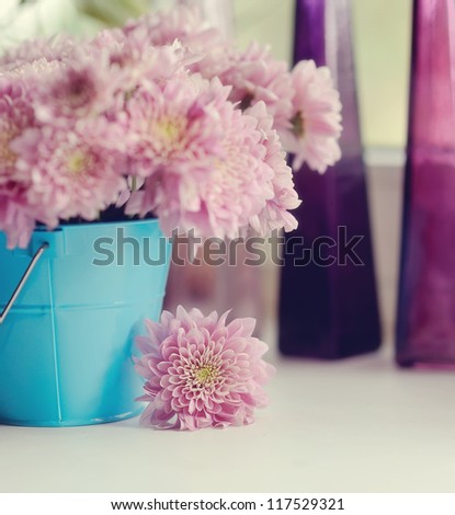 beautiful delicate bouquet of pink chrysanthemums in a blue bucket