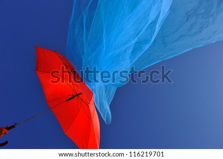 red umbrella and flying scarf