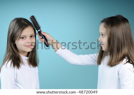 twins combing hair