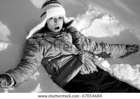 girl creating snow angels