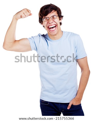 Laughing young man in glasses, blue t-shirt and jeans showing off his biceps isolated on white background