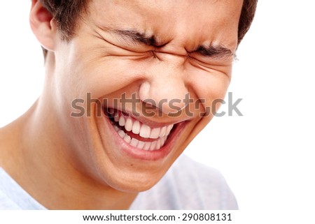 Close-up portrait of young man laughing out loud