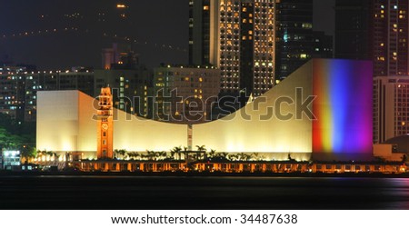 Hong Kong Cultural Centre with colorful light projection on its wall.