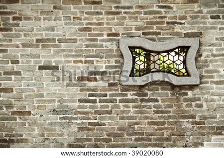 Chinese window on brick wall