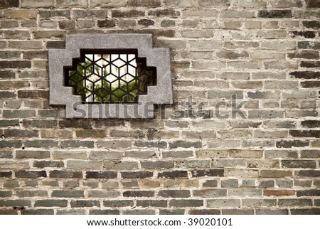 Chinese window on brick wall