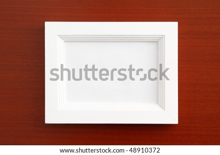Picture Frame for Home Decoration. White wooden photo frame on wooden background.